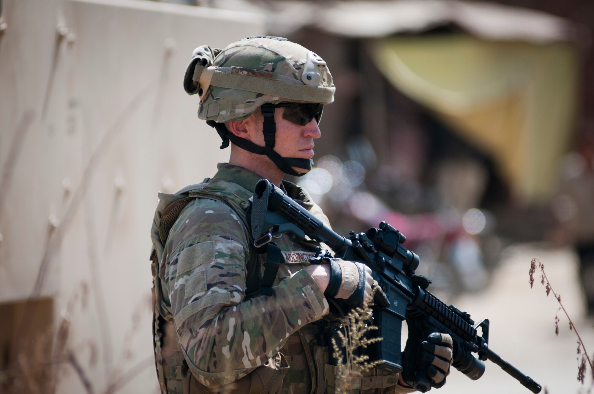 An Airman with the 455th Expeditionary Security Forces Squadron stands guard while Airmen deliver supplies to an Afghan National Police station outside Bagram Airfield, Afghanistan, Sept. 22, 2012. 455 ESFS is responsible for maintaining security around Bagram to ensure safe operations. (U.S. Air Force photo/SMSgt Dale Canofari)