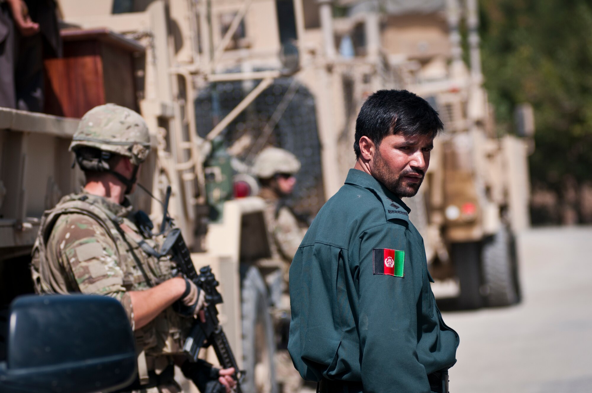 Afghan National Police officers and Airmen with the 455th Expeditionary Security Forces Squadron stand guard while Airmen deliver supplies to an Afghan National Police station outside Bagram Airfield, Afghanistan, Sept. 22, 2012. Bagram Airmen work closely with Afghan National Security Forces to maintain security around Bagram Airfield. (U.S. Air Force photo/SMSgt Dale Canofari)