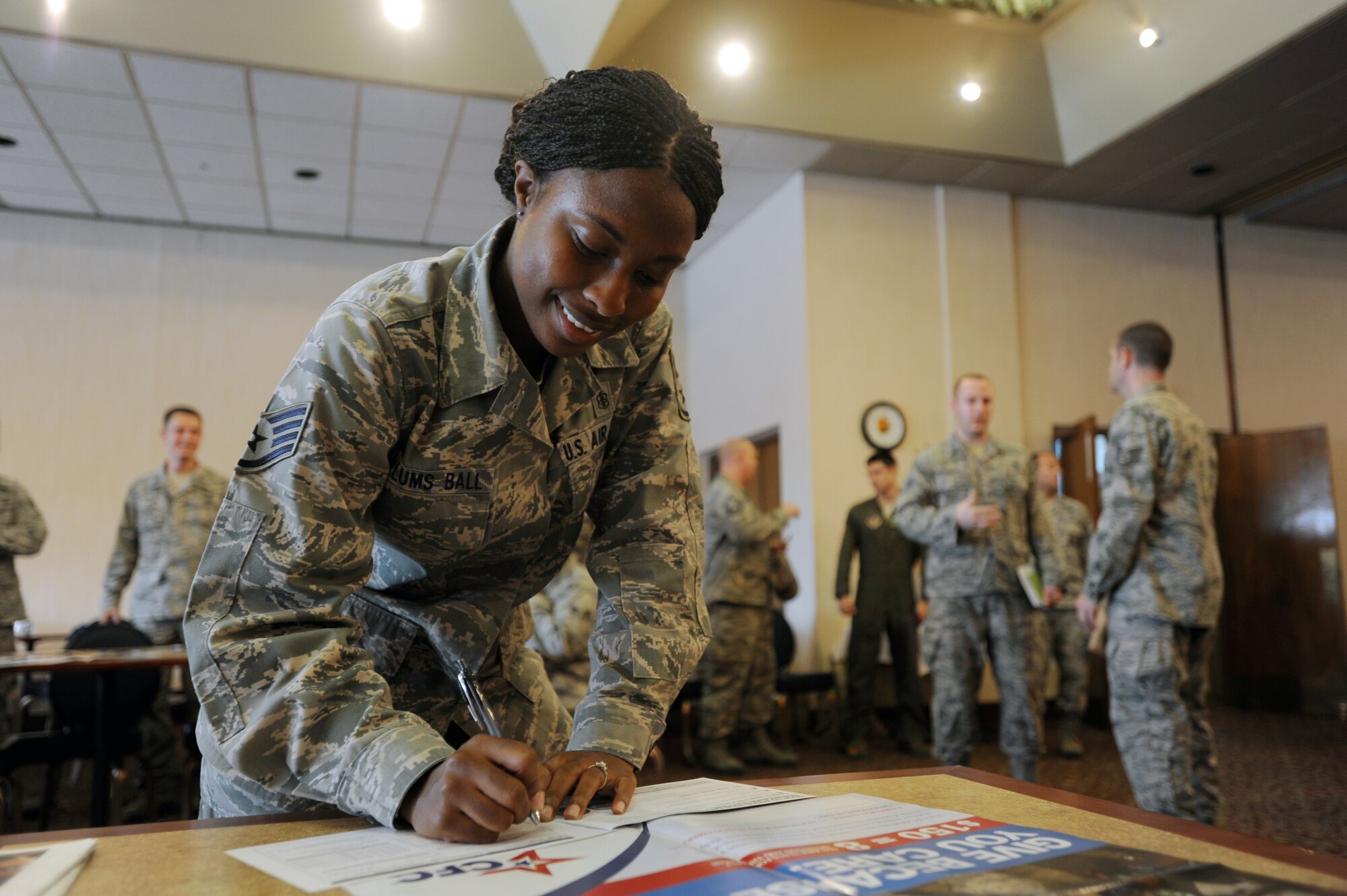 Staff Sgt. Nicole Allums Ball, 51st Medical Support Squadron NCO in charge of TRICARE, fills out a pledge card at the Combined Federal Campaign-Overseas kick-off ceremony Sept. 21, 2012, at the officer’s club at Osan Air Base, Republic of Korea. Federal employees have the option to make a one-time donation to a CFC charity of their choice or use a payroll deduction to take out a set portion of money each pay period. (U.S. Air Force photo/Airman 1st Class Alexis Siekert)