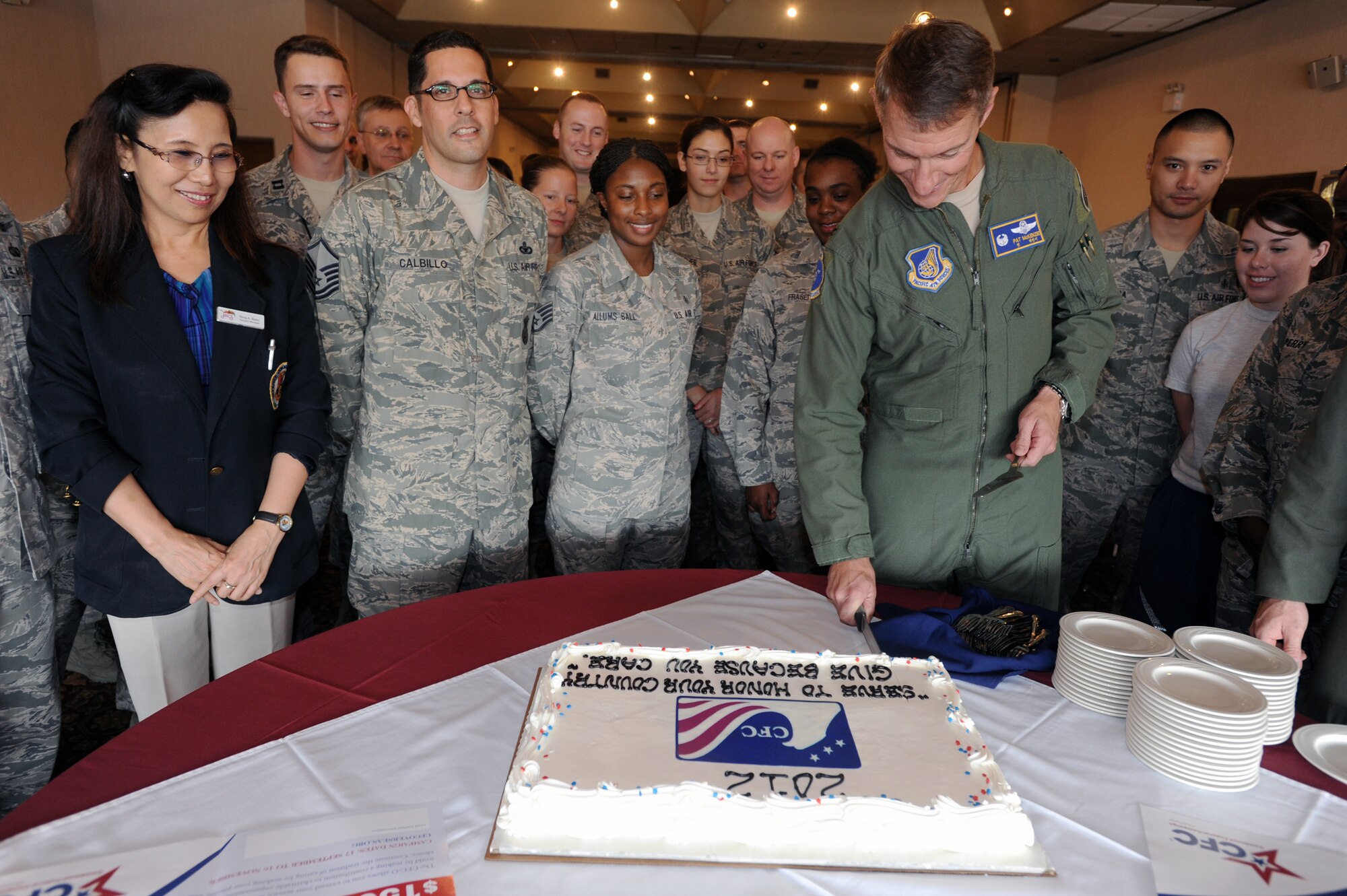 Col. Patrick McKenzie, 51st Fighter Wing commander, cuts a cake at the Combined Federal Campaign-Overseas kick-off ceremony Sept. 21, 2012, at the officer’s club at Osan Air Base, Republic of Korea. The CFC-O gives federal employees the opportunity to donate funds to more than 2,500 charitable organizations. The campaign runs through Nov. 16. (U.S. Air Force photo/Airman 1st Class Alexis Siekert)