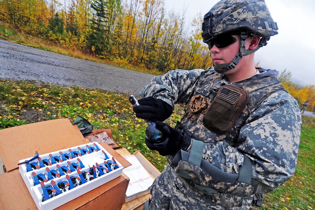 Army Spc. Kevin Wolford removes shrapnel from the inside of a practice hand grenade for the next soldier at the station on Joint Base Elmendorf-Richardson, Alaska, Sept. 20, 2012. Wolford is assigned to 545th Military Police Company.