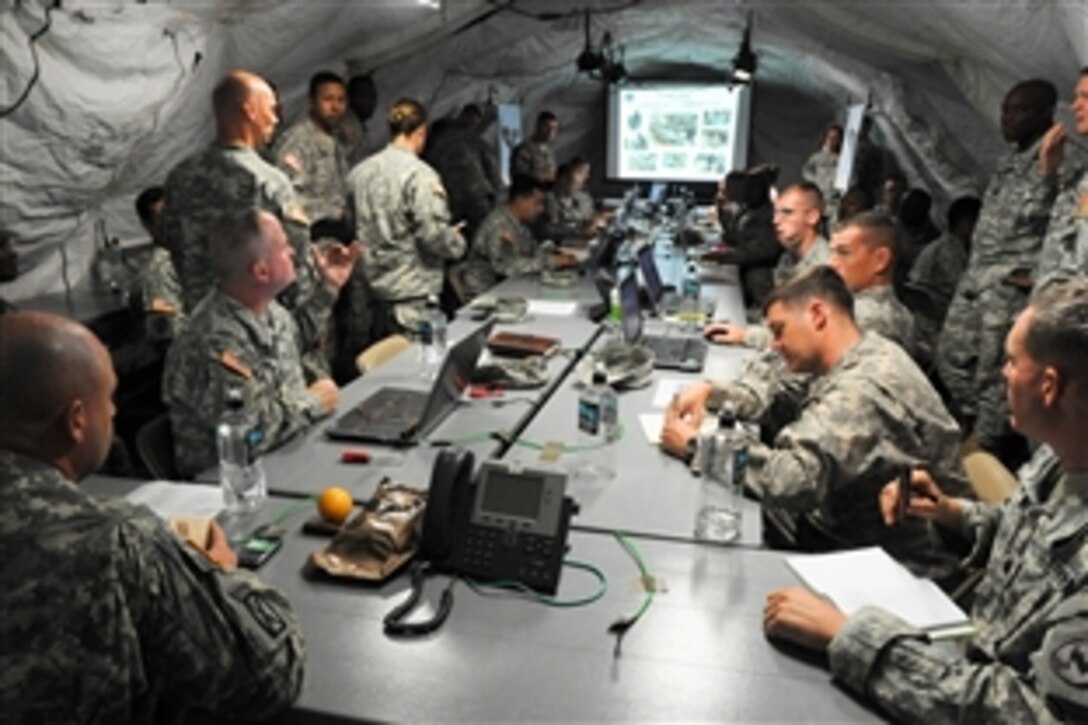 Soldiers assigned to the U.S. Army Pacific Contingency Command Post conduct a humanitarian assistance and disaster relief coordination meeting during a readiness exercise on the Taliai Military Camp,Tonga, Sept. 25, 2012. The exercise is part of Coral Reef - a multinational emergency deployment and readiness exercise with partners in Australia, New Zealand and Tonga. 