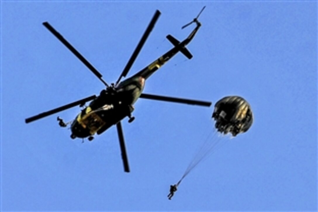 U.S. and Romanian soldiers perform a parachute jump from a Slovakian helicopter during exercise Jackal Stone 2012 in Udbina, Croatia, Sept. 17, 2012. 