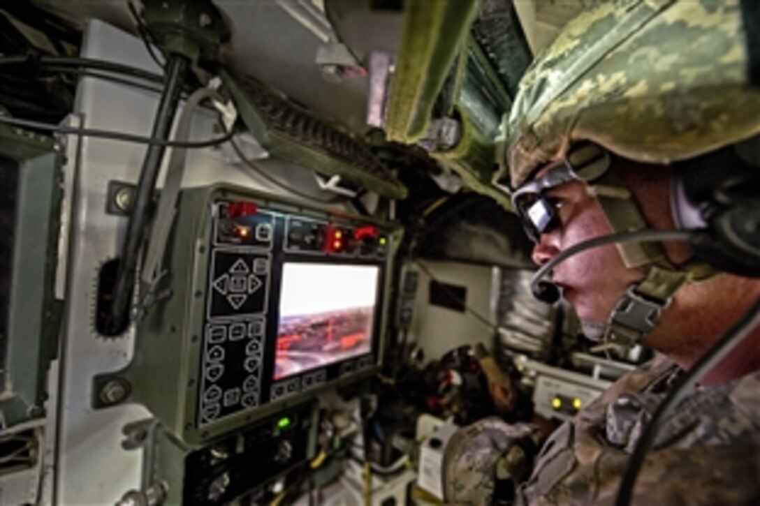 U.S. Army Spc. Warren Feeley looks through a fire control system inside an M1126 infantry carrier vehicle while engaging targets with a .50-caliber remote weapons system during a live-fire training exercise on Pohakuloa Training Area, Hawaii, Sept. 19, 2012. Feeley is assigned to the 25th Infantry Division's Company A, 1st Battalion, 21st Infantry Regiment, 2nd Stryker Brigade Combat Team.