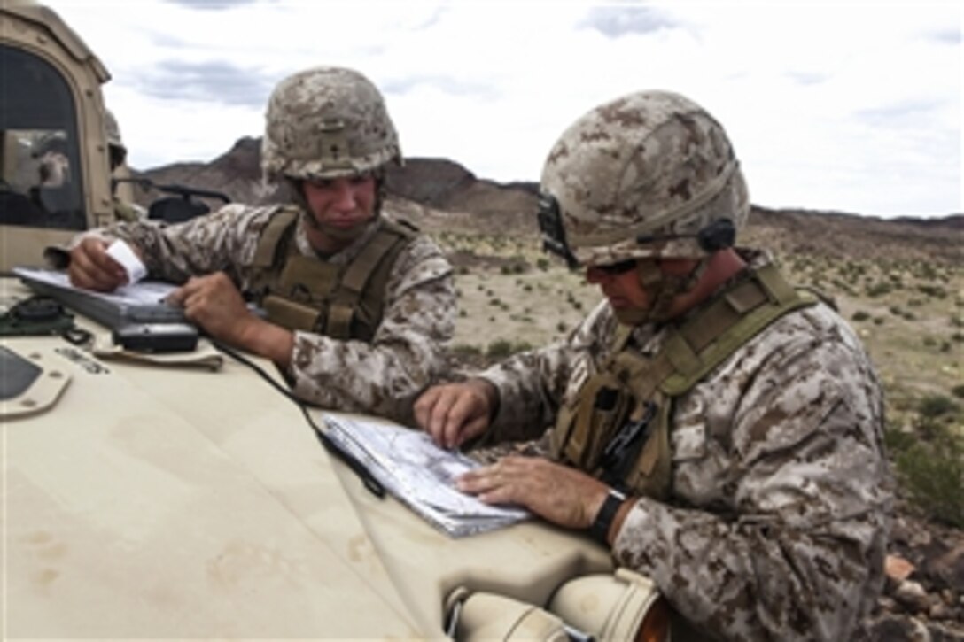 Marine Corps Pfc. Devlin Linhardt, left, and Cpl. Justin Abbott prepare for an artillery call for fire during Enhanced Mojave Viper on Marine Corps Air Ground Combat Center Twentynine Palms, Calif., Sept. 22, 2012.