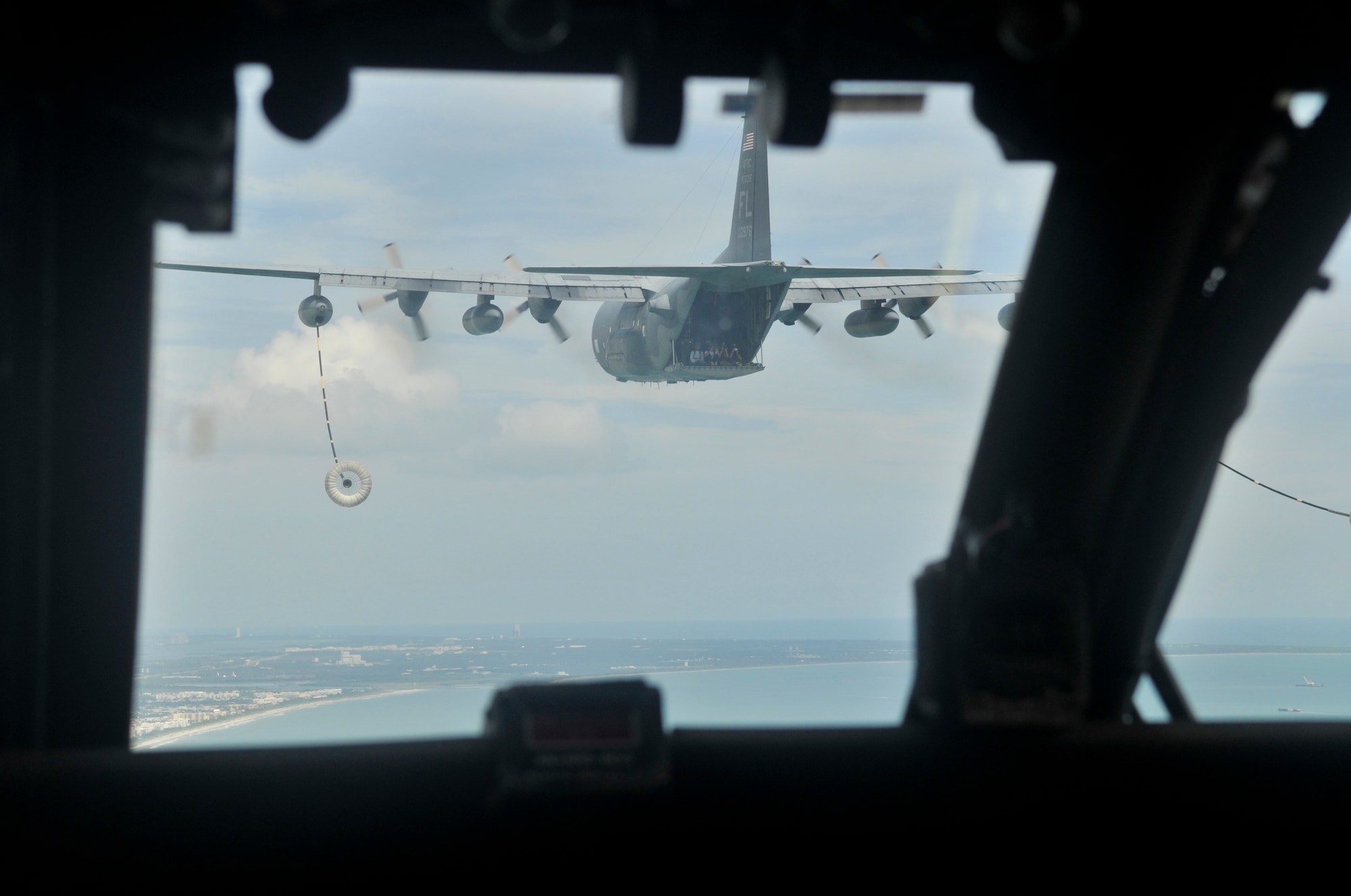 Local media can be seen on the ramp of an HC-130 P/N King refueling aircraft from the cockpit off an HH-60G Pave Hawk helicopter. Rescue Reservists from the 920th Rescue Wing, Patrick Air Force Base, Fla., performed a mid-air refuel as well as a combat-search-and-rescue demonstration during the Cocoa Beach Air Show Sept. 22-23. (U.S. Air Force photo/Tech. Sgt. Peter Dean)