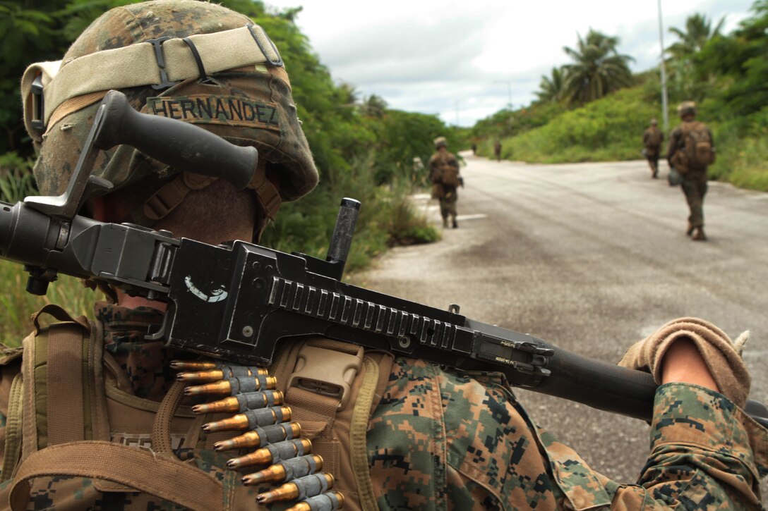 Lance Cpl. Jethel Hernandez, a machine gunner with Company G., Battalion Landing Team 2nd Battalion, 1st Marine Regiment, 31st Marine Expeditionary Unit and a native of Sioux City, Iowa, carries his M-240 machine gun while conducting a foot patrol during a helicopter raid on an enemy-held town here, September 22. The 31st MEU is the only continuously forward-deployed MEU and is the Marine Corps’ force in readiness in the Asia-Pacific region.