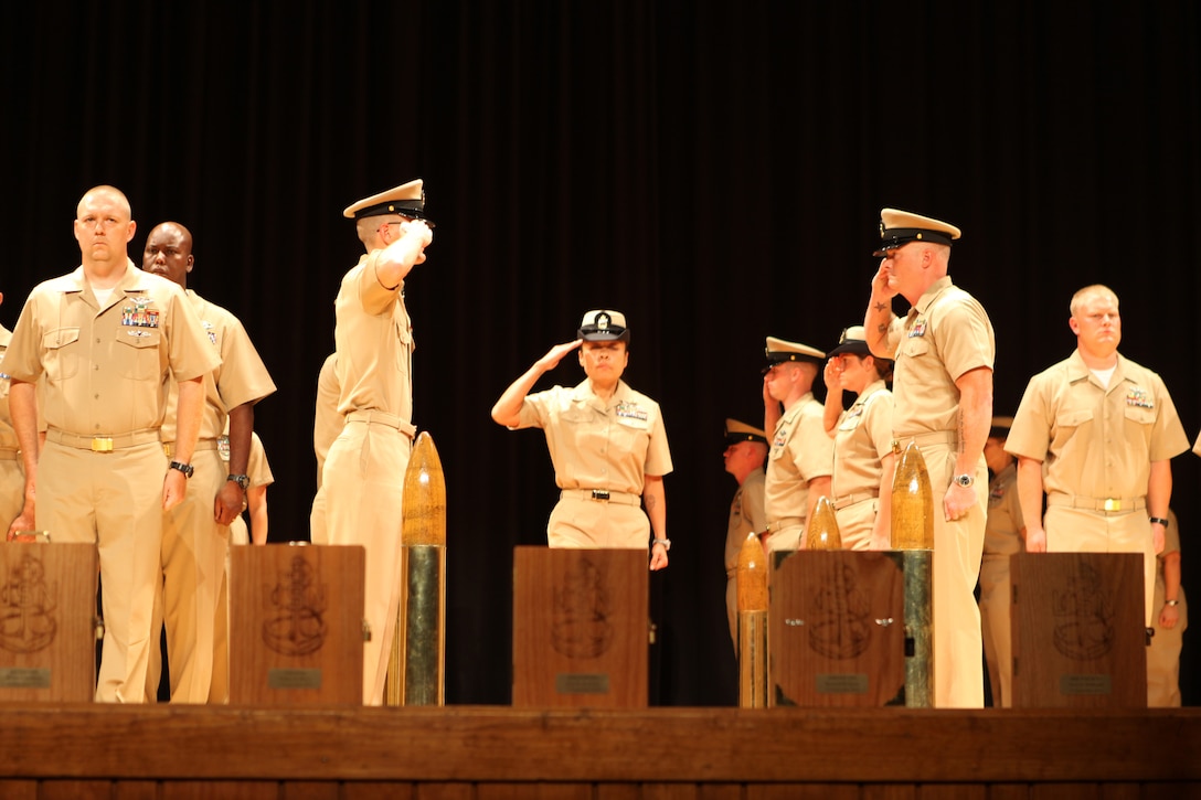 A new chief petty officer salutes as she is welcomed into the chief's mess during a pinning ceremony held aboard Marine Corps Base Camp Lejeune Sept. 14. The chief's mess is also known as the "goat locker". 