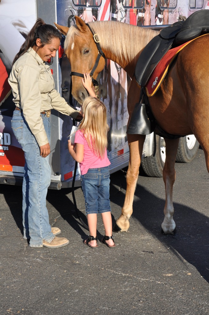 Corporal Cherisess E. Paige, a stableman aboard Marine Corps Logistics Base Barstow Calif., showcases Okinawa, also known as Dean, a horse from MCLB’s Mounted Color Guard to Bartow locals. MCLB’s MCG will be featured in this year’s 24th annual Barstow Rodeo Stampede taking place at the Marine Corps Logistics Arena, Yermo Annex, Friday, Sept. 28 and Saturday, Sept. 29. The rodeo will also feature bull riding, barrel racing, roping, bronco riding, and more.  
