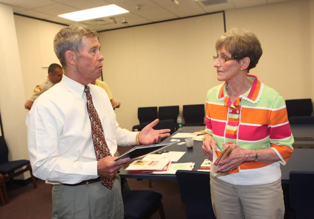 Retired Marine Col. Joe Yannessa, the chairman of the Jacksonville Onslow County Crime Stoppers, speaks to Carolyn Randall, the area manager with Sussex, England, Crime Stoppers, during the Jacksonville Onslow County Crime Stoppers’ board meeting hosted at Jacksonville City Hall Sept. 20. Randall offered ideas on fundraising events and organization sponsorship. 