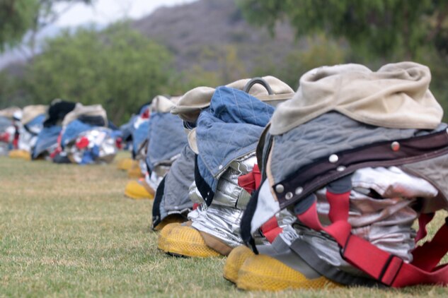 Flame and heat resistant bunker gear are lined up waiting for the Marines of Marine Corps Air Station Camp Pendleton, MCAS Yuma and MCAS Miramar during the 2012 Aircraft Rescue Fire Fighting Rodeo at Lake O'Neil aboard Marine Corps Base Camp Pendleton, Calif., Sept. 22.
