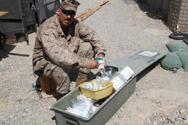 Petty Officer 2nd Class David Cergol, a corpsman with the battalion aid station, 2nd Battalion, 7th Marine Regiment, organizes a box of medical supplies, Sept. 25. Cergol spent his first enlistment as a Seabee and deployed during the initial push into Iraq.