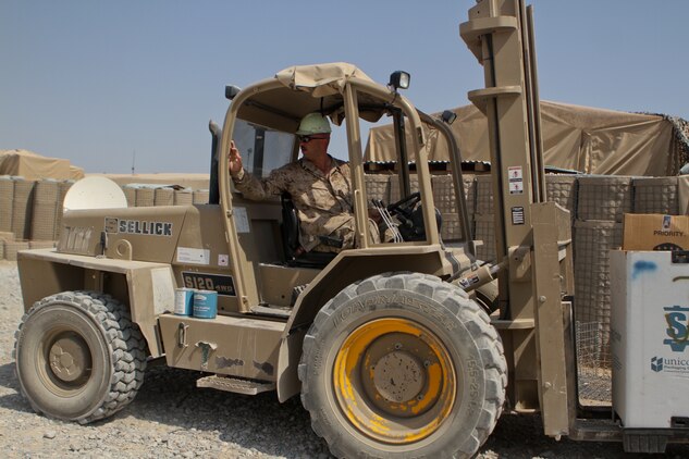 Petty Officer 2nd Class David Cergol, a corpsman with the battalion aid station, 2nd Battalion, 7th Marine Regiment, operates a forklift, Sept. 25. Cergol earned his license to drive a number of heavy equipment when he was a Seabee. He uses his skills and certifications to help the Marines and sailors.