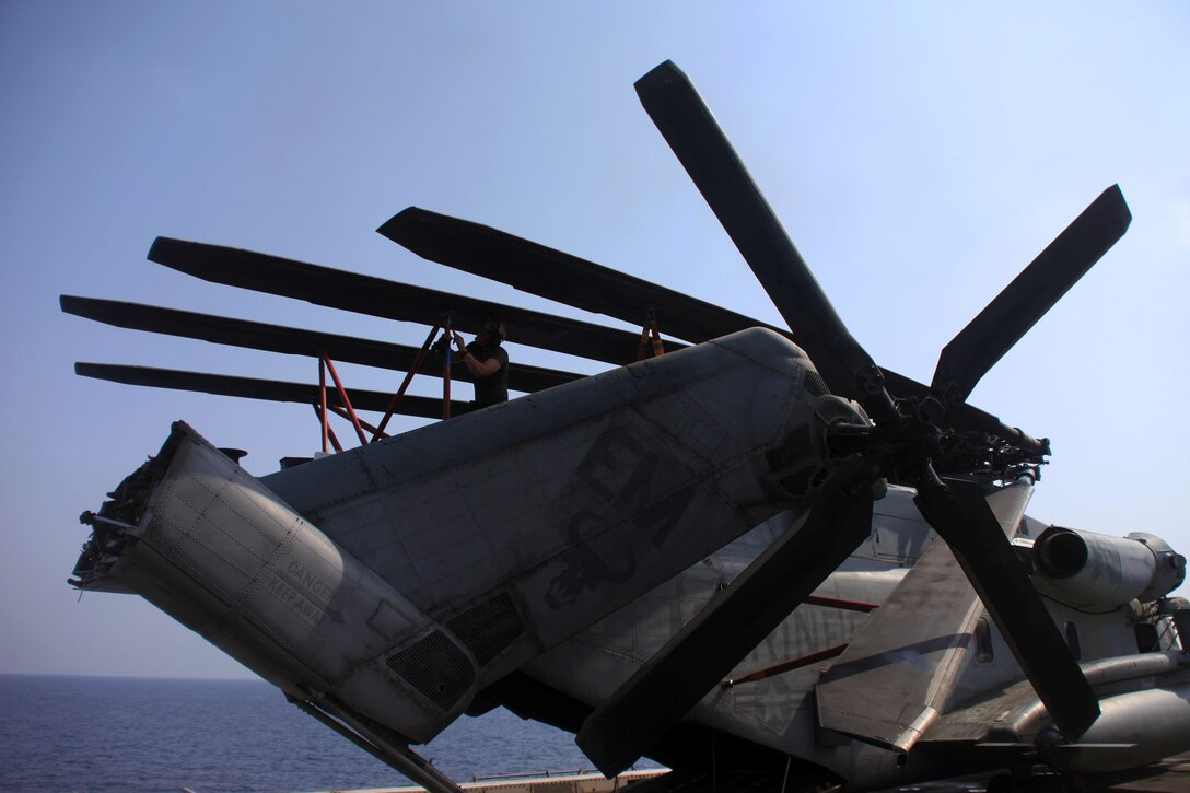 Cpl. Lonnie Bowen, a Polk City, Fla., native and flight-line mechanic with Marine Medium Tiltrotor Squadron 261 (Reinforced), 24th Marine Expeditionary Unit, performs corrosion preventative maintenance on a CH-53E Super Stallion helicopter aboard the USS New York, Sept. 26.