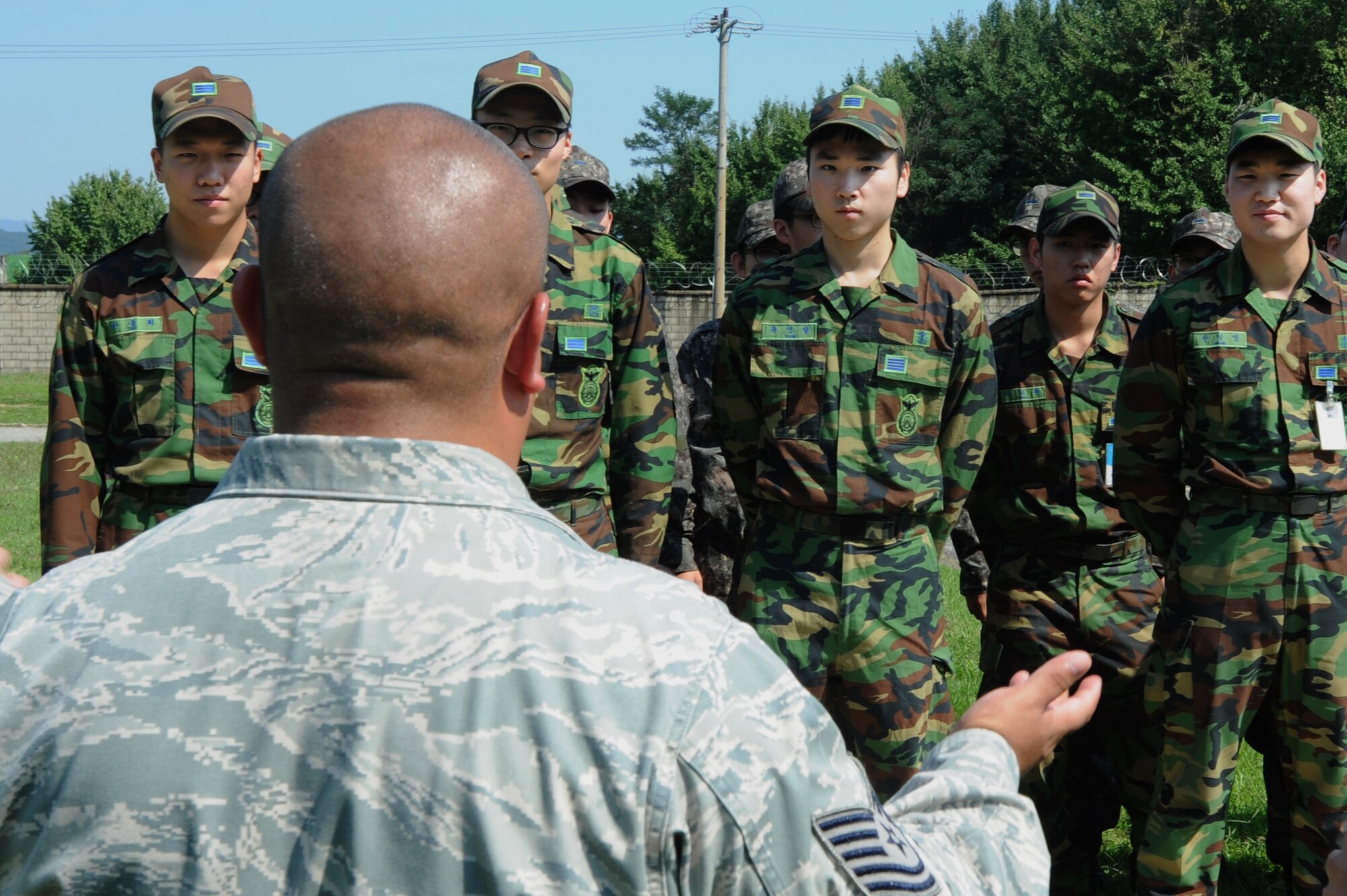 Tech. Sgt. Eric Morales, 51st Security Forces Squadron military working dog kennel master, briefs Republic of Korea Air Force Air Police Squadron members on the mission of the military working dogs at Osan Air Base Sept. 24, 2012. Osan’s kennel is the largest operational kennel in the Air Force.  (U.S. Air Force photo/Airman 1st Class Alexis Siekert)