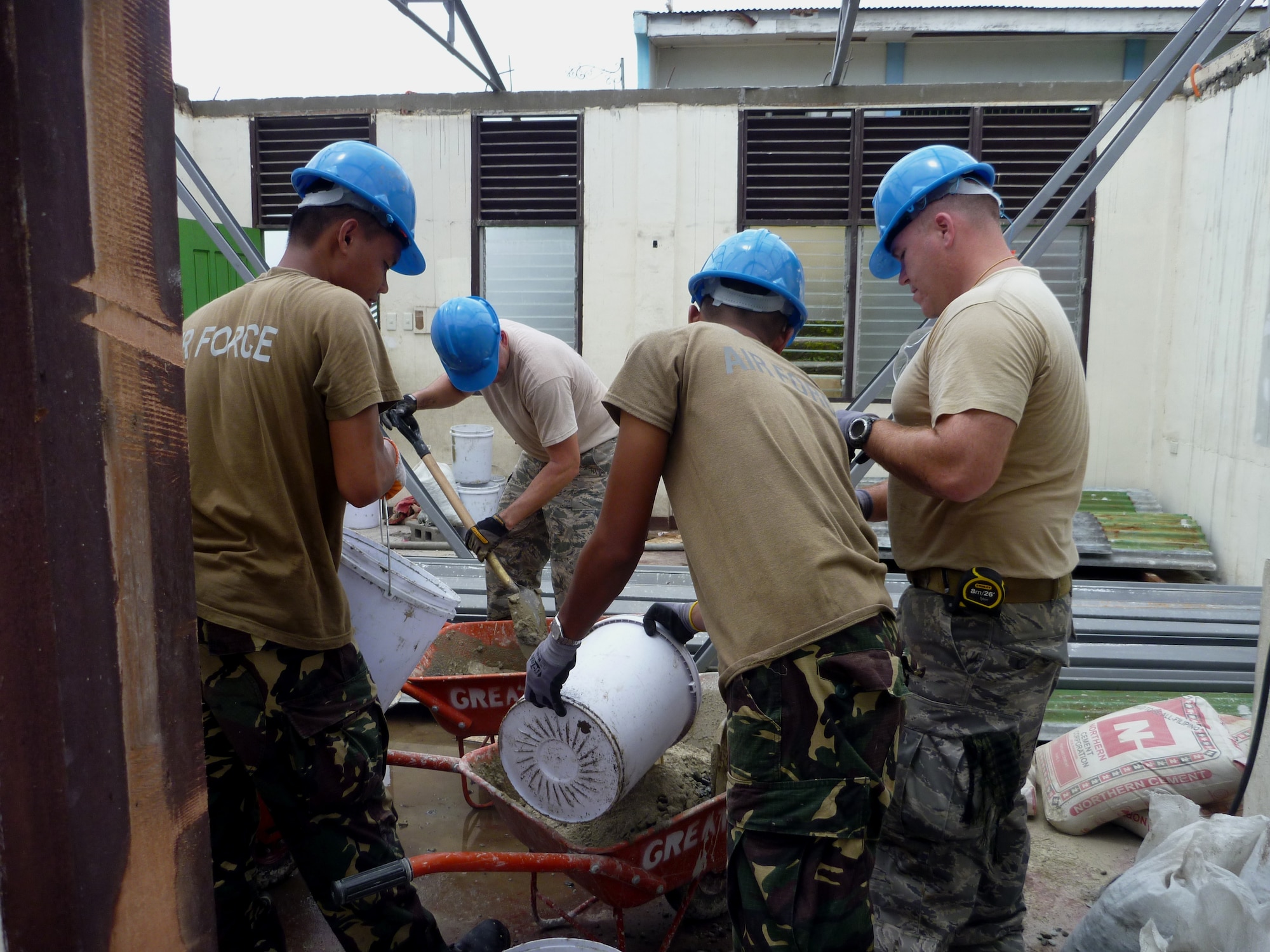 Airmen from the 647th Civil Engineering Squadron, Joint-Based Pearl Harbor-Hickam, Hawaii, mix concrete with Airmen from the 355th Aviation Engineering Wing, Basa, Philippines, at Cacutud Elementary School in Malabacat, Philippines Aug. 29. The more than 400 students who attend the school now have renovated classrooms and a new schoolhouse as a result of Airmen from the U.S. Air Force, Philippine Air Force and local contractors who spent the past month working in support of Pacific Unity 12-6. Pacific Unity is a bilateral Engineering Civic Action Program (ENCAP) conducted in the Asia-Pacific region in collaboration with host nation civil authorities and military personnel under the direction and coordination of 13th Air Force, Joint-Based Pearl Harbor-Hickam, Hawaii. (U.S. Air Force photo by Staff Sgt. Derek York/Released).