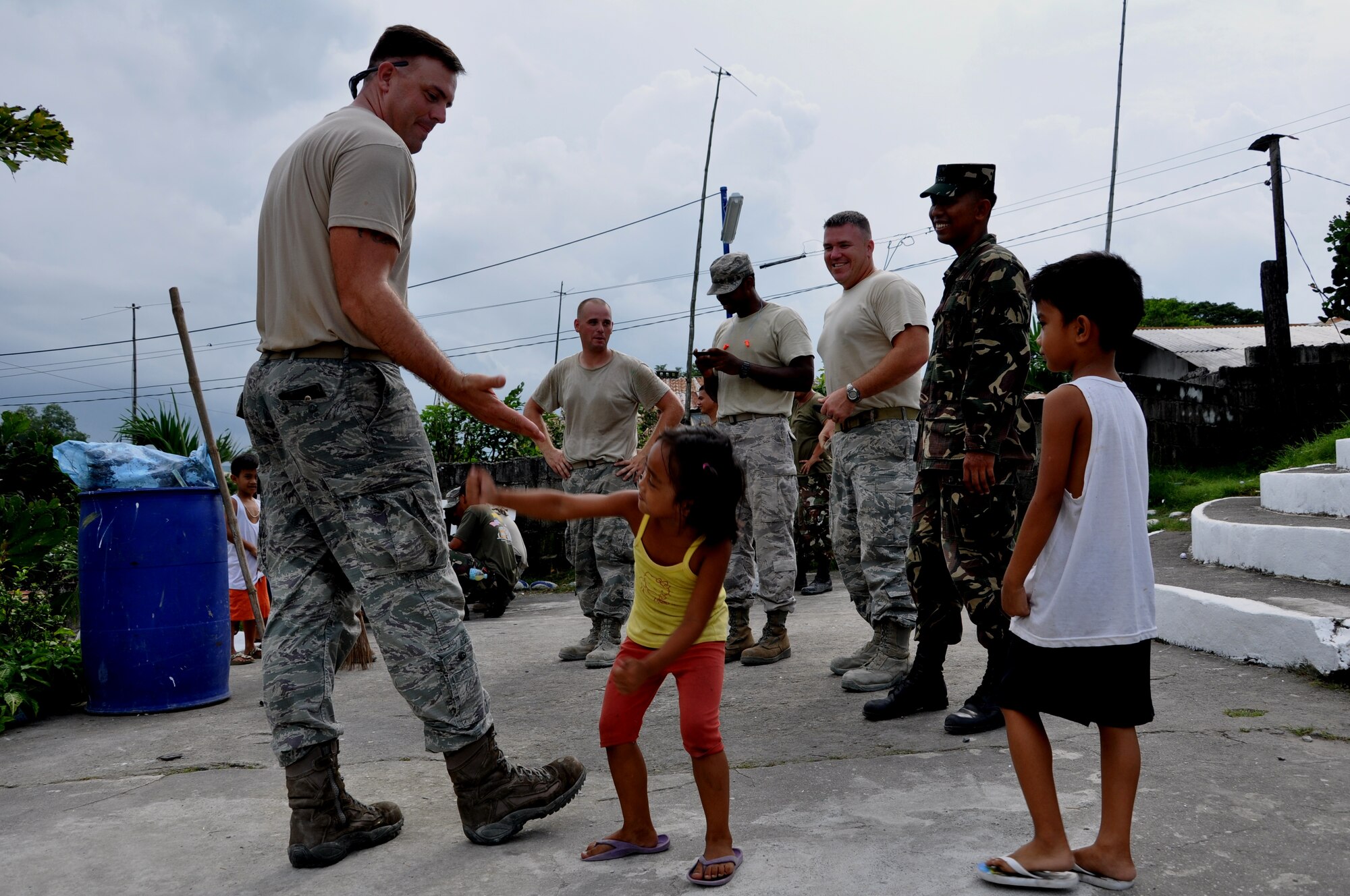 Staff Sgt. Derek York, 647th CES water and fuels systems maintenance craftsman and a plumber for Pacific Unity 12-6 gets a high five from one of the students of Cacatud Elementary School in Malabacat, Philippines Sept. 18. The more than 400 students who attend the school now have renovated classrooms and a new schoolhouse as a result of Airmen from the U.S. Air Force, Philippine Air Force and local contractors who spent the past month working in support of Pacific Unity 12-6. Pacific Unity is a bilateral Engineering Civic Action Program (ENCAP) conducted in the Asia-Pacific region in collaboration with host nation civil authorities and military personnel under the direction and coordination of 13th Air Force, Joint-Based Pearl Harbor-Hickam, Hawaii. (U.S. Air Force photo by Staff Sgt. Derek York/Released).