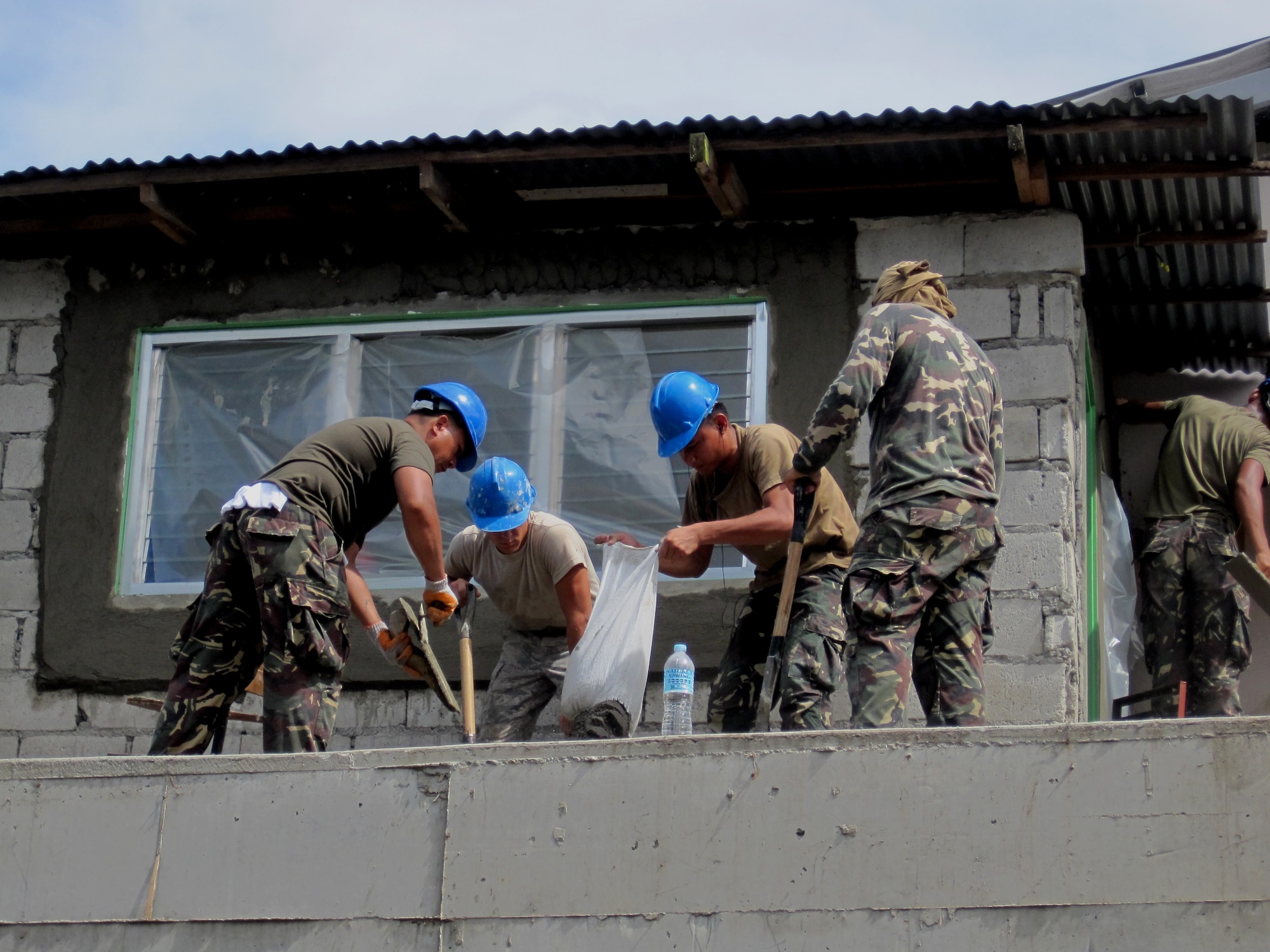 Airmen from the 647th Civil Engineering Squadron, Joint-Based Pearl Harbor-Hickam, Hawaii, mix concrete with Airmen from the 355th Aviation Engineering Wing, Basa, Philippines, at Cacutud Elementary School in Malabacat, Philippines Aug. 29. The more than 400 students who attend the school now have renovated classrooms and a new schoolhouse as a result of Airmen from the U.S. Air Force, Philippine Air Force and local contractors who spent the past month working in support of Pacific Unity 12-6. Pacific Unity is a bilateral Engineering Civic Action Program (ENCAP) conducted in the Asia-Pacific region in collaboration with host nation civil authorities and military personnel under the direction and coordination of 13th Air Force, Joint-Based Pearl Harbor-Hickam, Hawaii. (U.S. Air Force photo courtesy of 647th Civil Engineering Squadron/Released).