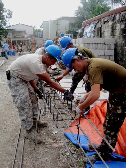 Airmen from the 647th Civil Engineering Squadron, Joint-Based Pearl Harbor-Hickam, Hawaii, prepare rebar for the pillars of a new schoolhouse with Airmen from the 355th Aviation Engineering Wing, Basa, Philippines, at Cacutud Elementary School in Malabacat, Philippines Aug. 28, 2012. The more than 400 students who attend the school now have renovated classrooms and a new schoolhouse as a result of Airmen from the U.S. Air Force, Philippine Air Force and local contractors who spent the past month working in support of Pacific Unity 12-6. Pacific Unity is a bilateral Engineering Civic Action Program (ENCAP) conducted in the Asia-Pacific region in collaboration with host nation civil authorities and military personnel under the direction and coordination of 13th Air Force, Joint-Based Pearl Harbor-Hickam, Hawaii. (U.S. Air Force photo)