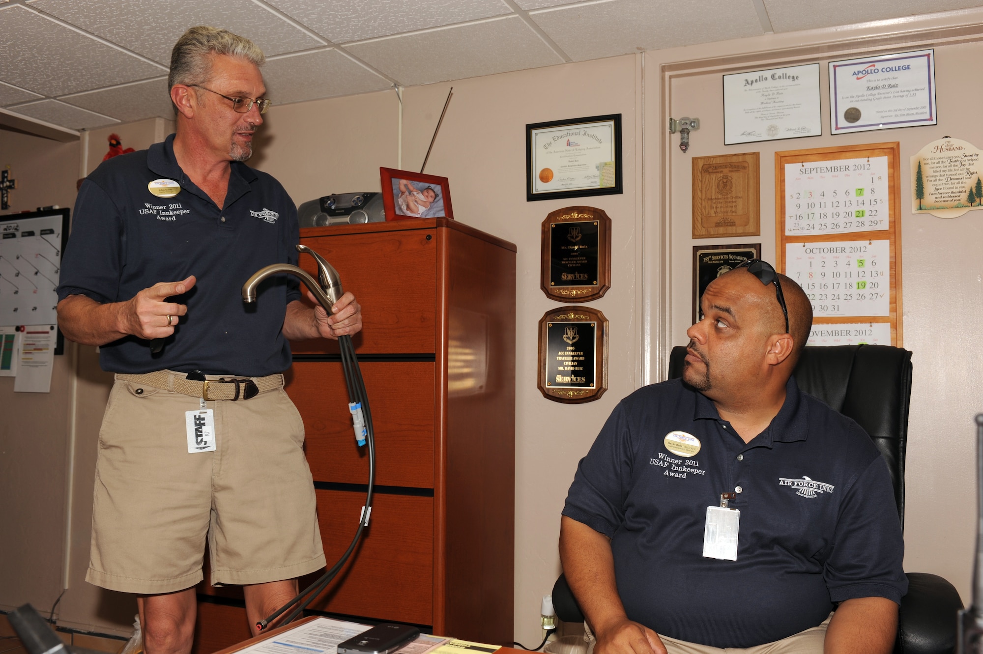 John Kubly (left), 355th Force Support Squadron supply manager, and David Ruiz, 355th FSS lodging assistant general manager, talk about the new faucets for the guest rooms at the Inn on Davis-Monthan on Davis-Monthan Air Force Base, Ariz., Sept. 19, 2012. Kubly and Ruiz work together to ensure that the inn receives adequate supplies while precluding or minimizing fraud, waste, and abuse. (U.S. Air Force photo by Airman 1st Class Timothy Moore/Released)