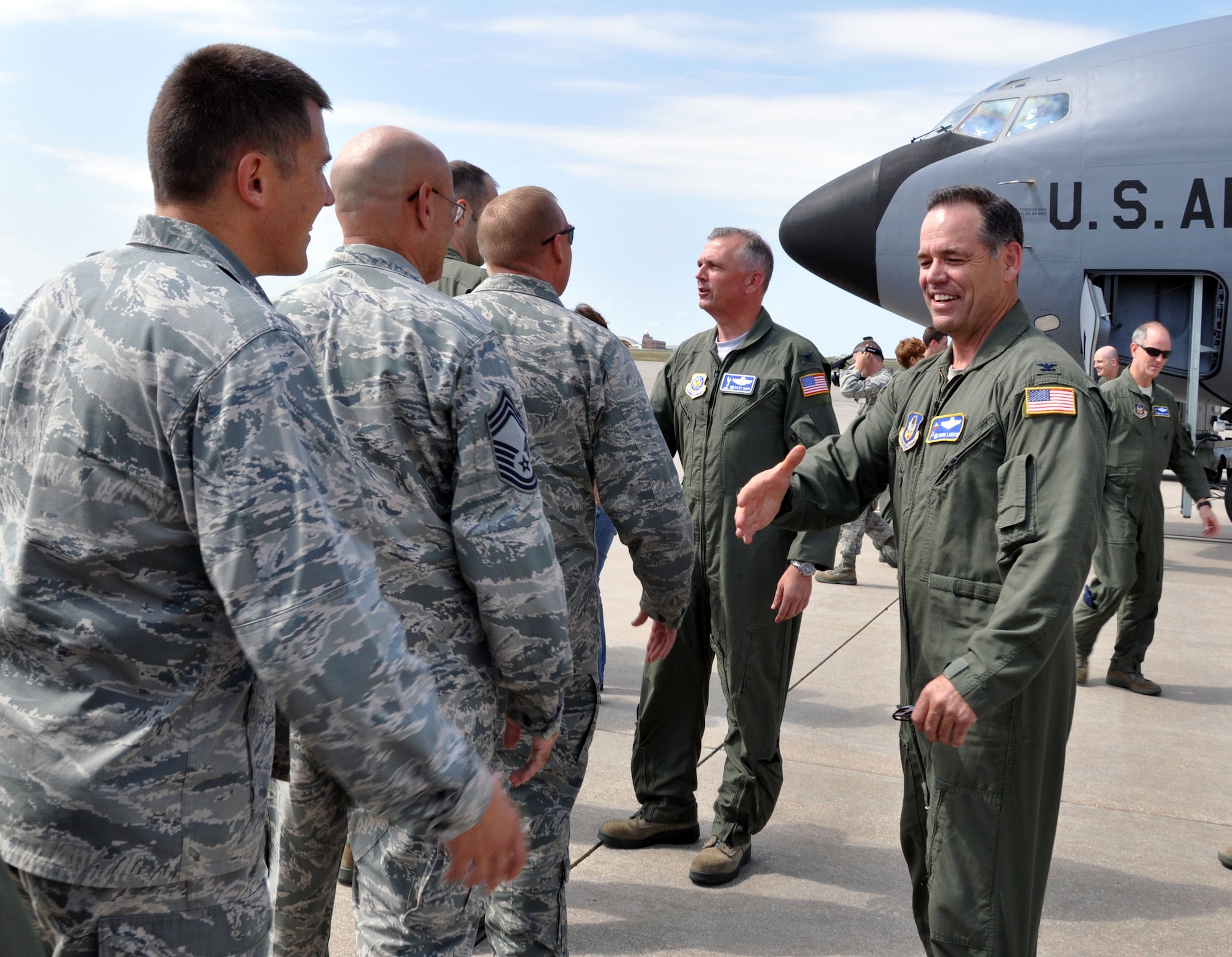 Col. Ricky N. Rupp, commander, 22nd Air Refueling Wing, and Col. Mark S. Larson, commander, 931st Air Refueling Group, congratulate members of Team McConnell following the 931st's final local mission of fiscal year 2012.  The 931st achieved its target of flying 3, 688 hours for the fiscal year on the final local mission.  (U.S. Air Force photo by 1st Lt. Zach Anderson)
