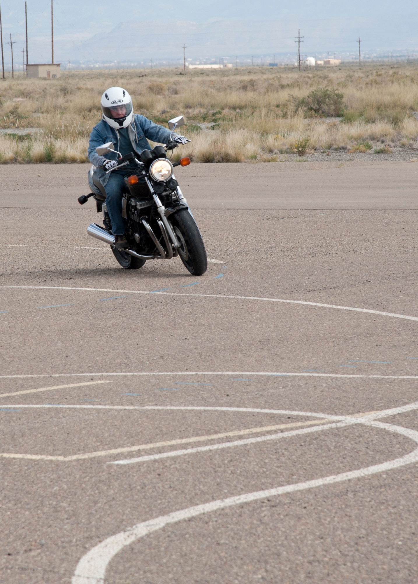 A participant completes a turning drill during the Experienced Rider course at Holloman AFB, N.M., Sept. 25. The beginner and expert classes are designed to help riders of every experience level to become better motorcycle riders. In accordance with Air Force Instruction 91-207, riders must take an appropriate motorcycle safety foundation course to ride on and off duty.  (U.S. Air Force photo by Airman 1st Class Colin Cates/Released)

