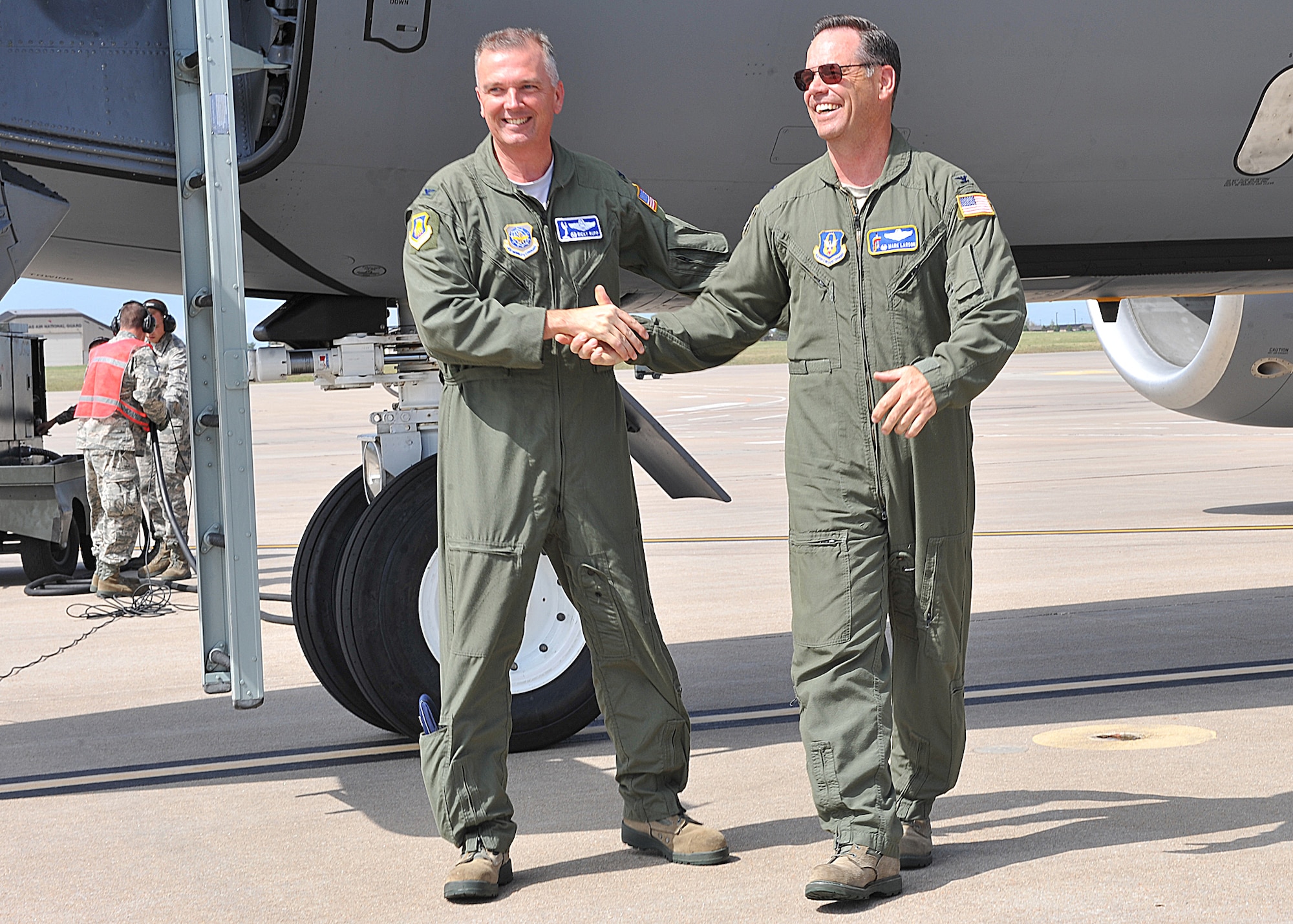 Col. Ricky Rupp, 22nd Air Refueling Wing commander, congratulates Col. Mark Larson, 931st Air Refueling Group commander, Sept. 26, 2012, McConnell Air Force Base, Kan. The 931st ARG accomplished their target for the 2012 fiscal year by achieving 3,688 flying hours. (U.S. Air Force photo/Airman 1st Class Maurice A. Hodges)