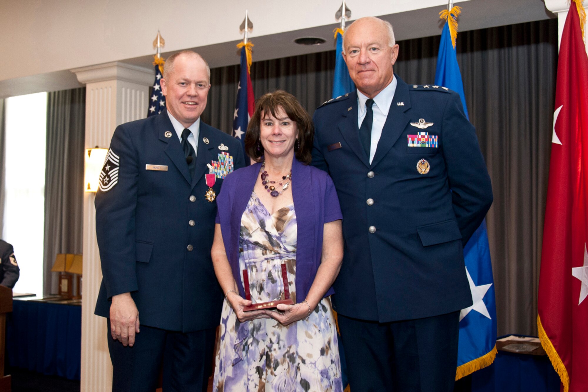 Lt. Gen. Harry Wyatt, Director of the Air National Guard, National Guard Bureau, Washington, D.C., presents the Chief of Staff of the Air Force award for exceptional public service to Monique Muncy, wife of Chief Master Sgt. Christopher E. Muncy, Command Chief Master Sergeant of the Air National Guard, National Guard Bureau, Washington, D.C., during Chief Muncy's retirement luncheon at Joint Base Anacostia-Bolling on Sept. 25, 2012. Muncy retired after thirty-five years of service to his country and held the position of Command Chief Master Sergeant of the Air National Guard since May 2009.  (National Guard photo by Master Sgt. Marvin Preston/RELEASED)