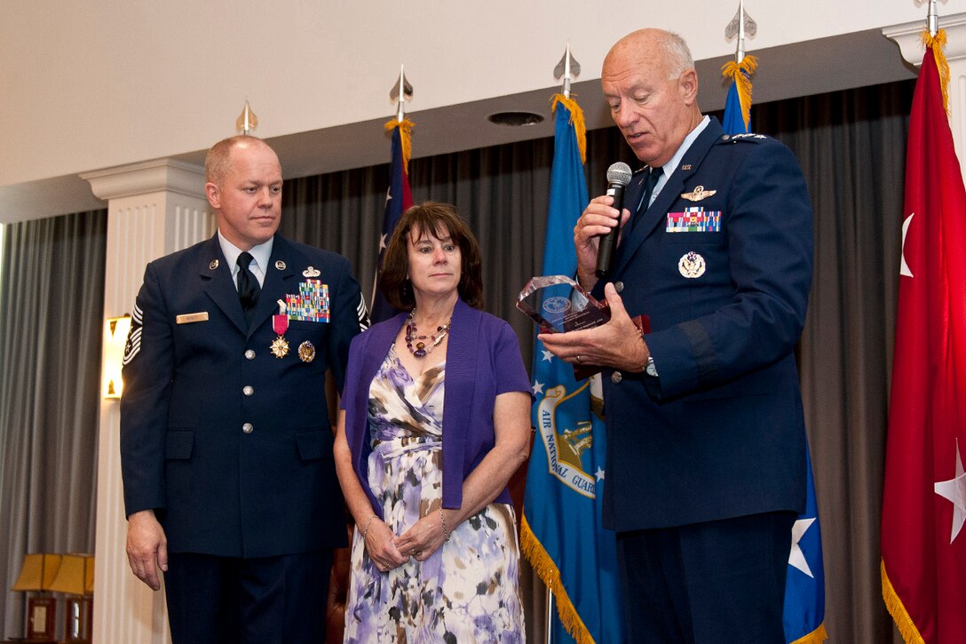 Lt. Gen. Harry Wyatt, Director of the Air National Guard, National Guard Bureau, Washington, D.C., presents the Chief of Staff of the Air Force award for exceptional public service to Monique Muncy, wife of Chief Master Sgt. Christopher E. Muncy, Command Chief Master Sergeant of the Air National Guard, National Guard Bureau, Washington, D.C., during Chief Muncy's retirement luncheon at Joint Base Anacostia-Bolling on Sept. 25, 2012. Muncy retired after thirty-five years of service to his country and held the position of Command Chief Master Sergeant of the Air National Guard since May 2009. (National Guard photo by Master Sgt. Marvin Preston/RELEASED)
