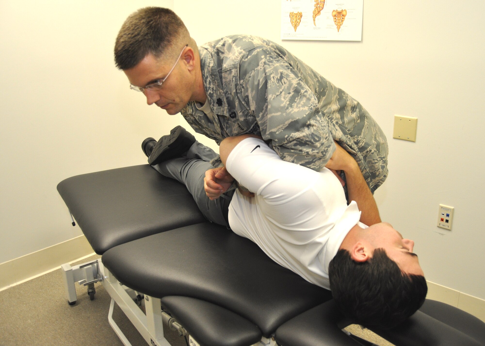 Lt. Col. John Childs, 81st Surgical Operations Squadron musculoskeletal research director, performs a lumbar spine manipulation on simulated patient, Kevin Wait’s, lower back Aept. 25, 2012, at the Keesler Hospital, Keesler Air Force Base, Miss. Wait is an 81st Surgical Operations Squadron physical therapist. Childs has been selected as the 2012 recipient of the Association of Military Surgeons of the United States Research & Development Award.  (U.S. Air Force photo by Steve Pivnick)