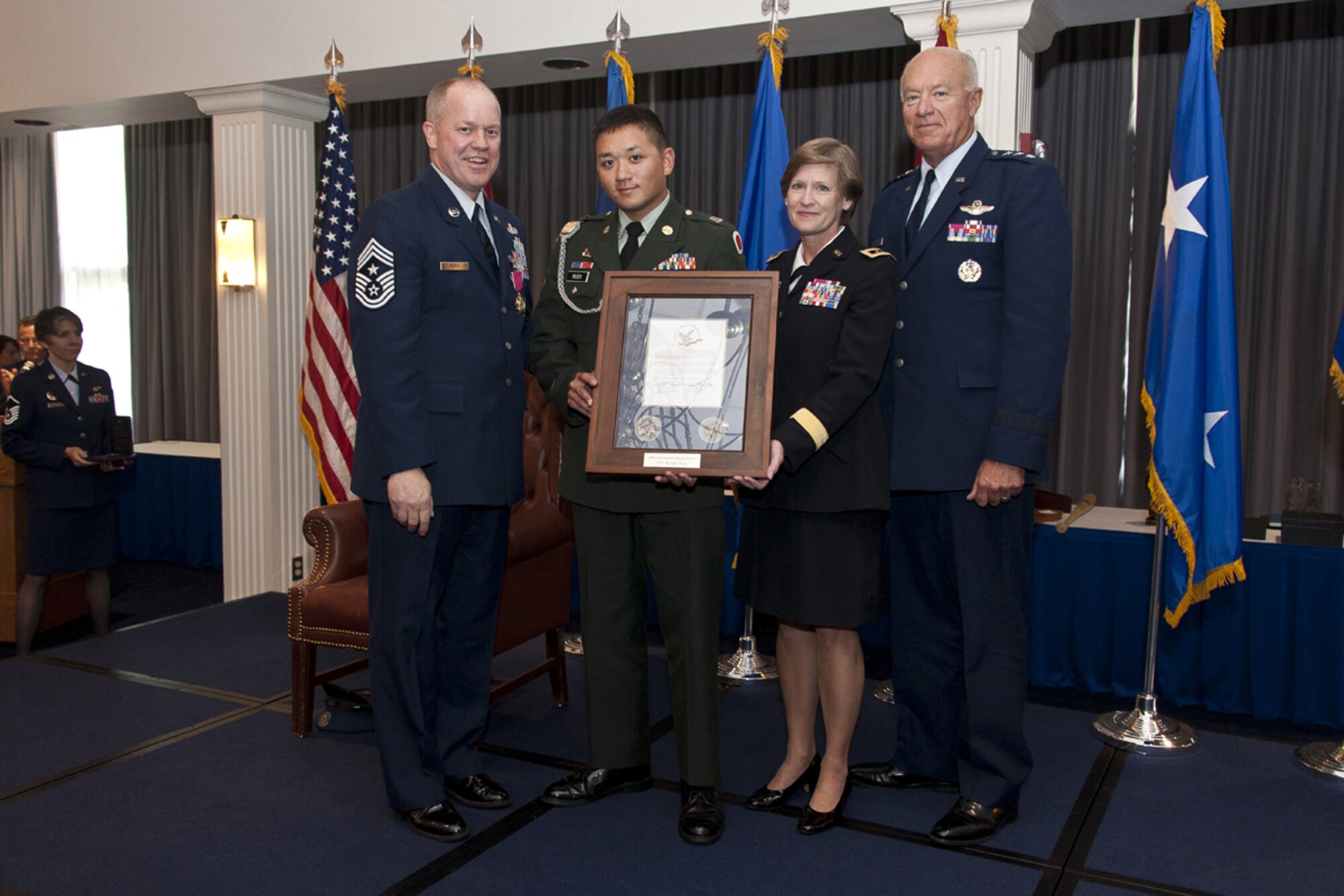 Chief Master Sgt. Christopher E. Muncy, Command Chief Master Sergeant of the Air National Guard, National Guard Bureau, Washington, D.C., poses with (left to right) Spc. Michael Rudy, 134th Field Artillery Regiment, Ohio Army National Guard, Maj. Gen. Deborah Ashenhurst, Adjutant General, Joint Force Headquarters, Ohio National Guard, and Lt. Gen. Harry Wyatt, Director of the Air National Guard, National Guard Bureau, Washington, D.C., after receiving a Hometown Hero's Salute Award during his retirement luncheon at Joint Base Anacostia-Bolling on Sept. 25, 2012.  Muncy retired after thirty-five years of service to his country and held the position of Command Chief Master Sergeant of the Air National Guard since May 2009.  (National Guard photo by Master Sgt. Marvin Preston/RELEASED)