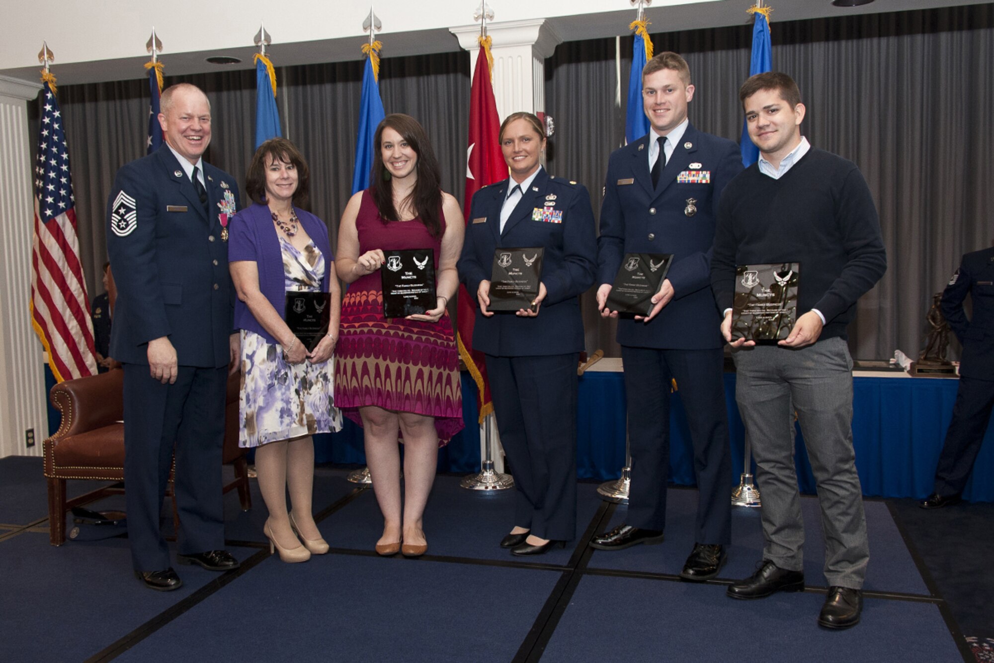 Chief Master Sgt. Christopher E. Muncy, Command Chief Master Sergeant of the Air National Guard, National Guard Bureau, Washington, D.C., presents plaques to his wife, Monique, and children, Becky, Aubrey, Paul, and Adam during his retirement luncheon at Joint Base Anacostia-Bolling on Sept. 25, 2012. The plaques included quotes from the family’s favorite movies.  (National Guard photo by Master Sgt. Marvin Preston/RELEASED)