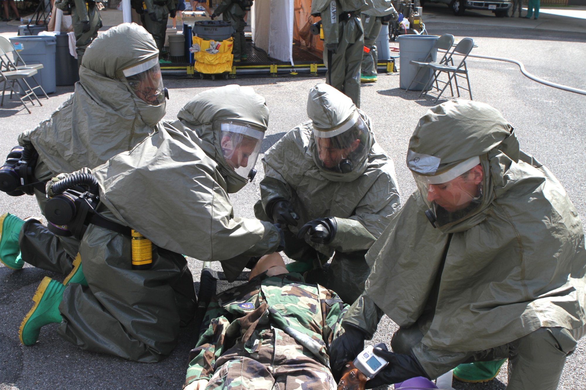 The in-place patient decontamination team cleans a “patient” at the decon wash station after cutting off his clothes during patient decontamination drills Sept. 14, 2012, at the Keesler Hospital, Keesler Air Force Base, Miss.  The 81st Medical Group continued fine-tuning all aspects of medical care for two upcoming major inspections: The Air Force Inspection Agency Health Service Inspection scheduled for Oct. 23-25 and the Oct. 29 through Nov. 5 Air Education Training Command Consolidated Unit Inspection.   (Courtesy photo by Dawson Love)