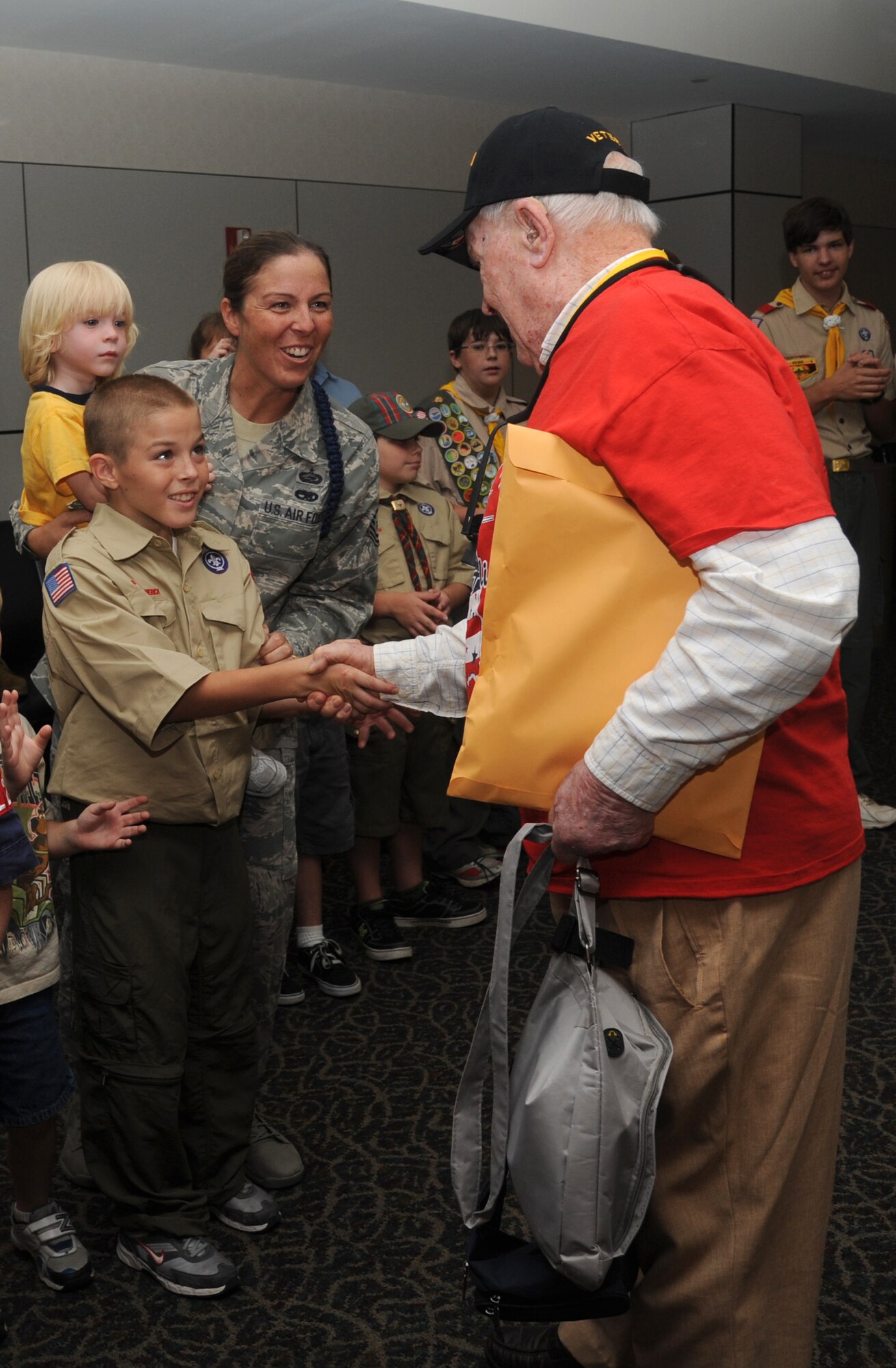 Tech. Sgt. Julie Hammond, 81st Training Group, Keesler Air Force Base, Miss., and her sons, Peyton, 2, and Easton, 10, welcome home Army veteran, Jack Haynes, at the fourth  Mississippi Gulf Coast Honor Flight to Washington, D.C., Sept 25, 2012, at the Gulfport/Biloxi International Airport. The Honor Flight program receives donations to honor our nation’s World War II veterans by sending them on a one-day visit to Arlington National Cemetery in Washington, D.C. (U.S. Air Force photo by Kemberly Groue)