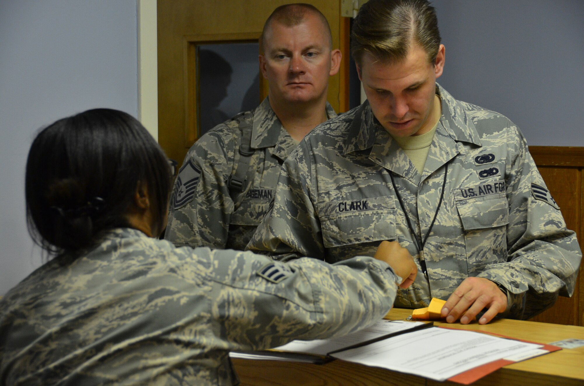 WRIGHT-PATTERSON AIR FORCE BASE, Ohio - Senior Airman Christopher Clark, 445th Logistics Readiness Squadron materiel management journeyman, has his dog tags checked here Sept. 17 by Senior Airman Va’Nesa Young, 88th Force Support Squadron, prior to his departure in support of the wing’s Operational Readiness Exercise held in Gulfport, Miss. (U.S. Air Force photo/Staff Sgt. Robert Nelson)