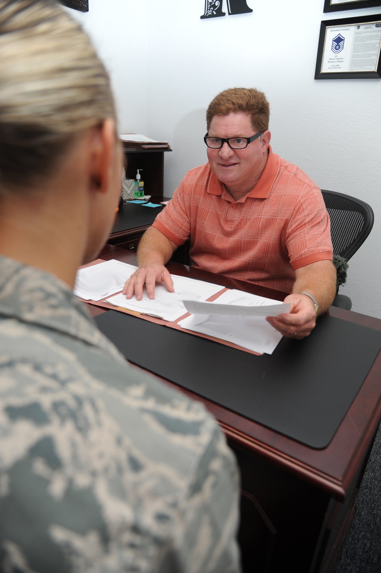 Ron Reagan, 81st Training Wing legal assistant, reviews legal discharging documents with an airman Sept. 25, 2012, at the Sablich Center, Keesler Air Force Base, Miss. (U.S. Air Force photo by Kemberly Groue)