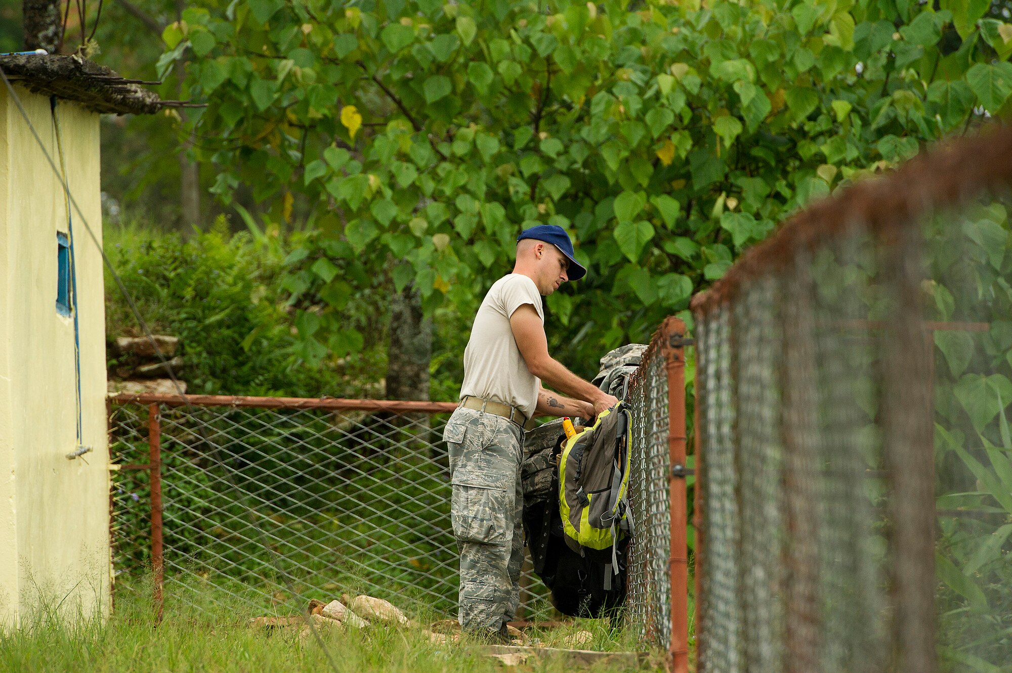 Staff Sgt. John Steklachick, 354th Civil Engineer Squadron, Eielson Air Force Base, Alaska, hangs his backpack from a fence before he starts work during U.S. Pacific Command's Operation Pacific Angel 12-4, Nepal, Sept. 10, 2012. Steklachick is a member of a team of U.S. Air Force and Nepalese army civil engineers renovating and constructing some buildings of Machhapuchhre Higher Secondary School of Dhikur Pokhari Village Development Committee. Pacific Angel 12-4 is a Pacific Air Forces planned event that enhances humanitarian assistance and disaster relief capabilities between the United States and Pacific partners. The U.S. was invited by the Nepal government to provide support by conducting medical, optometry and civil engineering programs. Operations like Pacific Angel build and sustain relationships with multinational partners in the Asia-Pacific region. (U.S. Air Force photo/Master Sgt. Jeffrey Allen)
