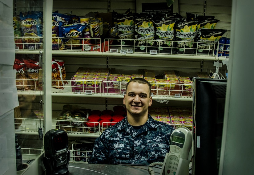 Ship's Serviceman Seaman Recruit Mike Miller tends the ship's store onboard USS Nicholas (FFG 47), Sept. 24, 2012, while the ship was moored pier side  during a routine port visit at the Charleston Port Terminal, Charleston, S.C. (U.S. Air Force Photo / Airman 1st Class Tom Brading)