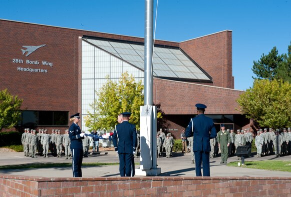 Airman 1st Class Tonya Criss, Staff Sgt. Michael Marr, Tech. Sgt. Michael Lewis, and Senior Airman Terrell Gray, from the Ellsworth Air Force Base Honor Guard fold the flag during a Prisoner of War, Missing in Action Remembrance ceremony in front of the 28th Bomb Wing Headquarters at Ellsworth Air Force Base, S.D., Sept. 22, 2012. The ceremony honored servicemembers listed as a POW MIA along with their families for their sacrifices to the cause of freedom. (U.S. Air Force photo by Airman 1st Class Zachary Hada/Released)