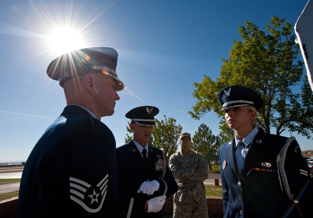Ellsworth Air Force Base Honor Guard members Staff Sgt. Michael Marr, Tech. Sgt. Michael Lewis, and Airman 1st Class Tonya Criss, rehearse folding the U.S. flag prior to the Prisoner of War, Missing in Action Remembrance retreat ceremony at Ellsworth Air Force Base, S.D., Sept. 22, 2012. The ceremony honored POWs, MIAs and their families for their sacrifices. (U.S. Air Force photo by Airman 1st Class Zachary Hada/Released) 