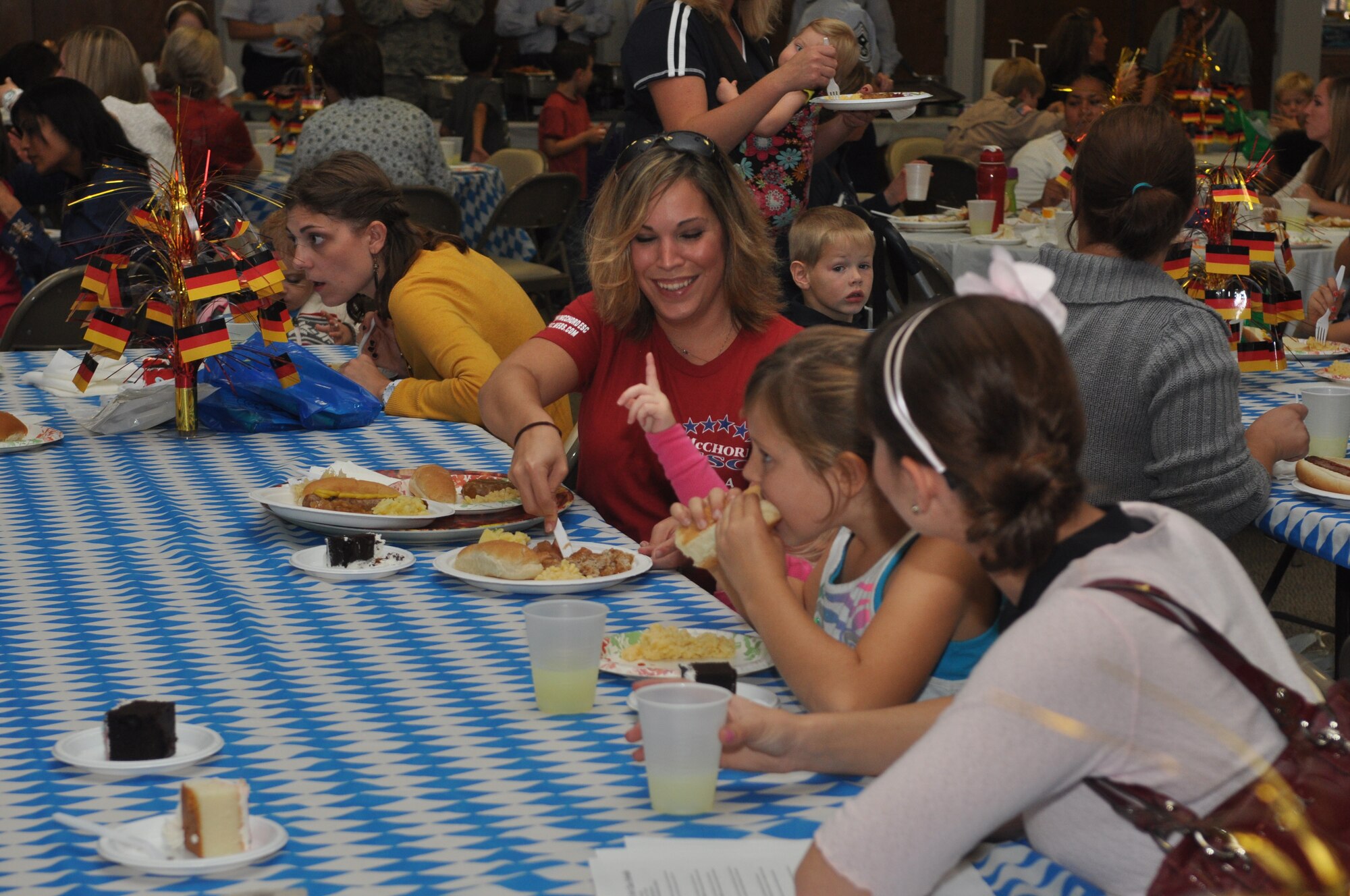 A family enjoys German themed food during the quarterly deployed families dinner at the McChord Field Chapel Support Center, Sept. 24, 2012 at Joint Base Lewis-McChord, Wash. The event is a time for family members of deployed Airmen to get together for sharing of stories and comraderie. (U.S. Air Force photo/Staff Sgt. Sean Tobin)