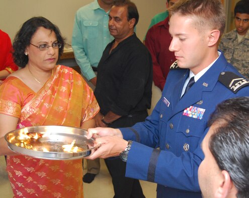 Cadet 2nd Class Ian Sweeney (center) participates in a Sri Ganesh Chaturthi at the Air Force Academy Cadet Chapel Sept. 21, 2012. Sweeney is assigned to Cadet Squadron 18. Also pictured are Mythili Bachu (left), chairperson of the Council of Hindu Temples of North America and president of the United Hindu Jain Temples of Washington, D.C., and Srinivasacharya Gudimella (right), a priest with the Sri Venkateswara Temple of Colorado in Castle Rock, Colo. The ceremony is held to honor the birthday of Ganesha, one of the major gods of the Hindu pantheon. (U.S. Air Force photo/Don Branum)