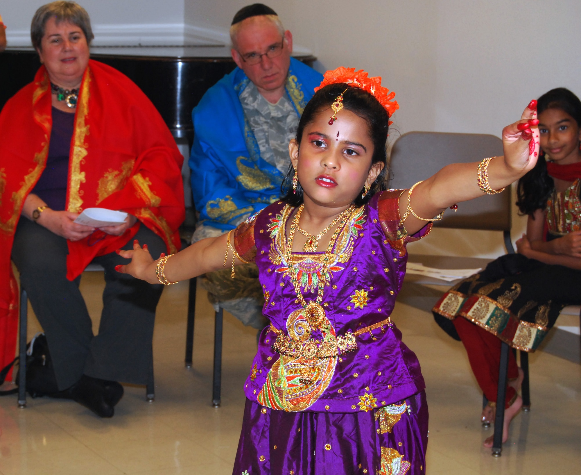 Srihitha Sayya (foreground) dances during a Sri Ganesh Chaturthi held in the Air Force Academy Cadet Chapel's multipurpose room Sept. 21, 2012. Among those also attending (background) were Adis Vila, the Academy's chief diversity officer; Chaplain (Maj.) Joshua Narrowe, a rabbi and the deputy Cadet Wing chaplain; and Akshitha Mudupu, a friend of Sayya's. The ceremony celebrates the birthday of Ganesha, one of the major deities in the Hindu pantheon. (U.S. Air Force photo/Don Branum)