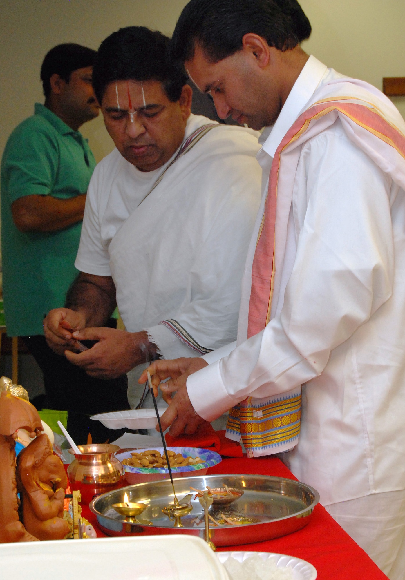 Sitaramacharyalu Gunturu and Srinivasacharya Gudimella prepare a Hindu altar for a Sri Ganesh Chaturthi observance in the Air Force Academy Cadet Chapel Sept. 21, 2012. Gunturu and Gudimella are priests with the Sri Venkateswara Temple of Colorado, based in Castle Rock, Colo. The festival celebrates the birthday of Ganesha, one of the major gods in the Hindu religion. (U.S. Air Force photo/Don Branum)