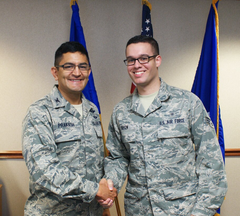 Col. Om. Prakash (left), 82nd Training Wing vice-commander, congratulates Senior Airman Michael Tryon, 82nd Medical Operations Squadron mental health technician, for being selected as the "Commander's Wingman of the Week" award winner for the week of Sept. 24-28 during the wing staff meeting at Sheppard Air Force Base, Texas, on Sept. 26, 2012.  The award is presented weekly to a Team Sheppard members who demonstrate outstanding duty performance, community involvement and exemplary leadership. (U.S. Air Force photo/Dan Hawkins)