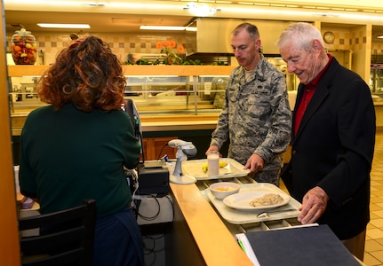 Retired Chief Master Sgt. of the Air Force Robert Gaylor and Chief Master Sgt. Larry Williams, 437th Airlift Wing command chief, pay for their breakfast at the Robert D. Gaylor dining facility, Sept. 21, 2012, at Joint Base Charleston - Air Base, S.C. Gaylor toured the Air Base and served as the guest speaker for various events during his visit. (U.S. Air Force photo/Staff Sgt. Rasheen Douglas)