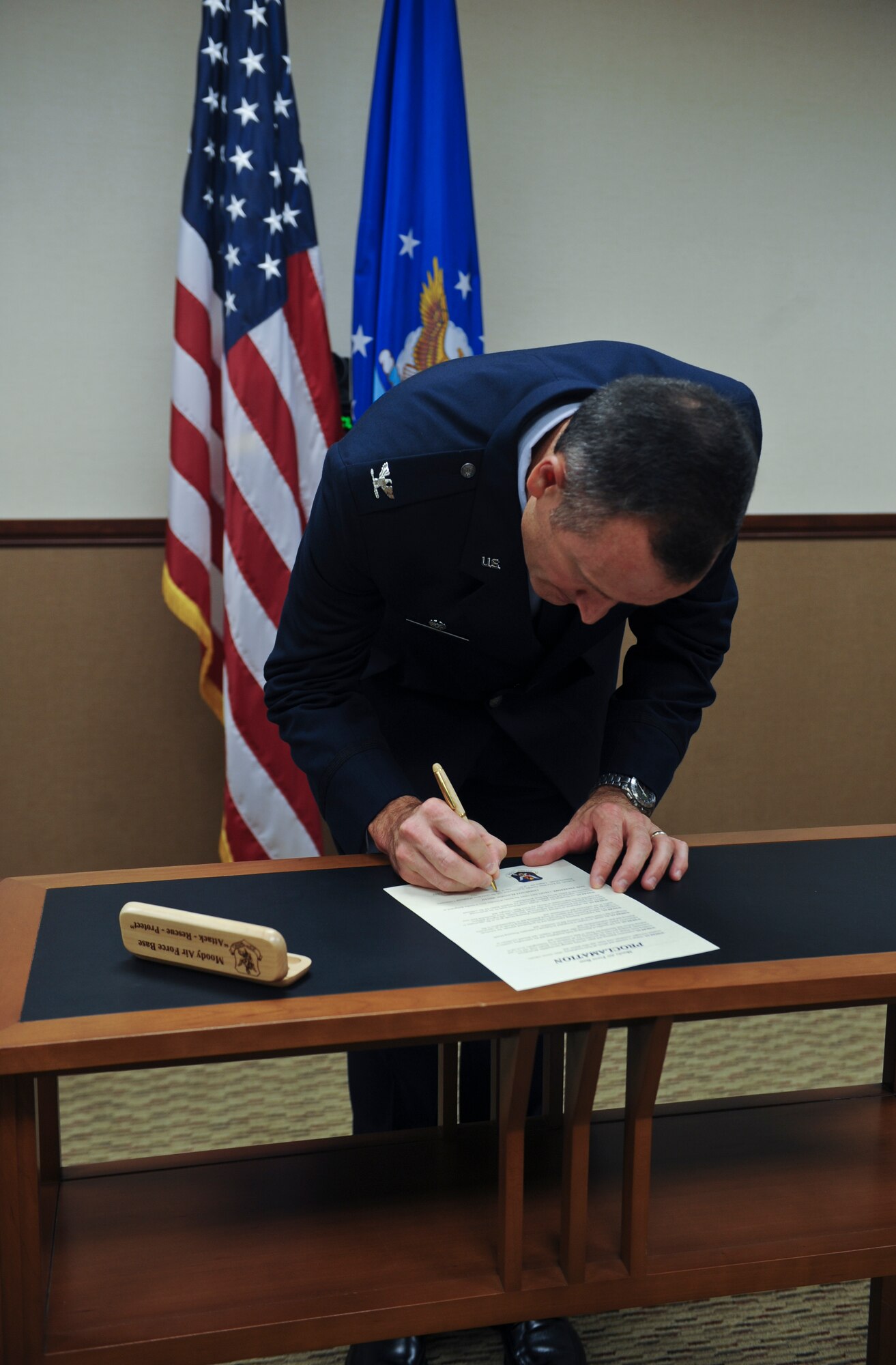 U.S. Air Force Col. Billy Thompson signs the Community Planning Month Proclamation at Moody Air Force Base, Ga., Sept. 20, 2012. In conjunction with the celebration of National Community Planning Month, Moody has designated October 2012 as Community Planning Month. (U.S. Air Force photo by Airman 1st Class Olivia Dominique/Released)