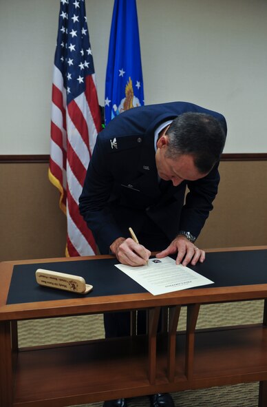 U.S. Air Force Col. Billy Thompson signs the Community Planning Month Proclamation at Moody Air Force Base, Ga., Sept. 20, 2012. In conjunction with the celebration of National Community Planning Month, Moody has designated October 2012 as Community Planning Month. (U.S. Air Force photo by Airman 1st Class Olivia Dominique/Released)