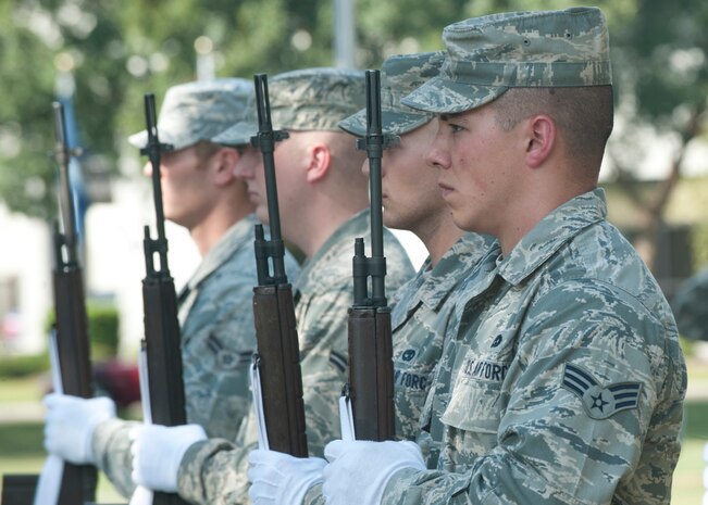 Joint Base Charleston Honor Guard members stand with their weapons during the Prisoner of War/Missing in Action Retreat ceremony held Sept. 21, 2012,at Joint Base Charleston – Air Base, S.C.. The honor guard members performed a 21-gun salute in honor of the nations POWs/MIAs. (U.S. Air Force photo / Staff Sgt. Katie Gieratz) 