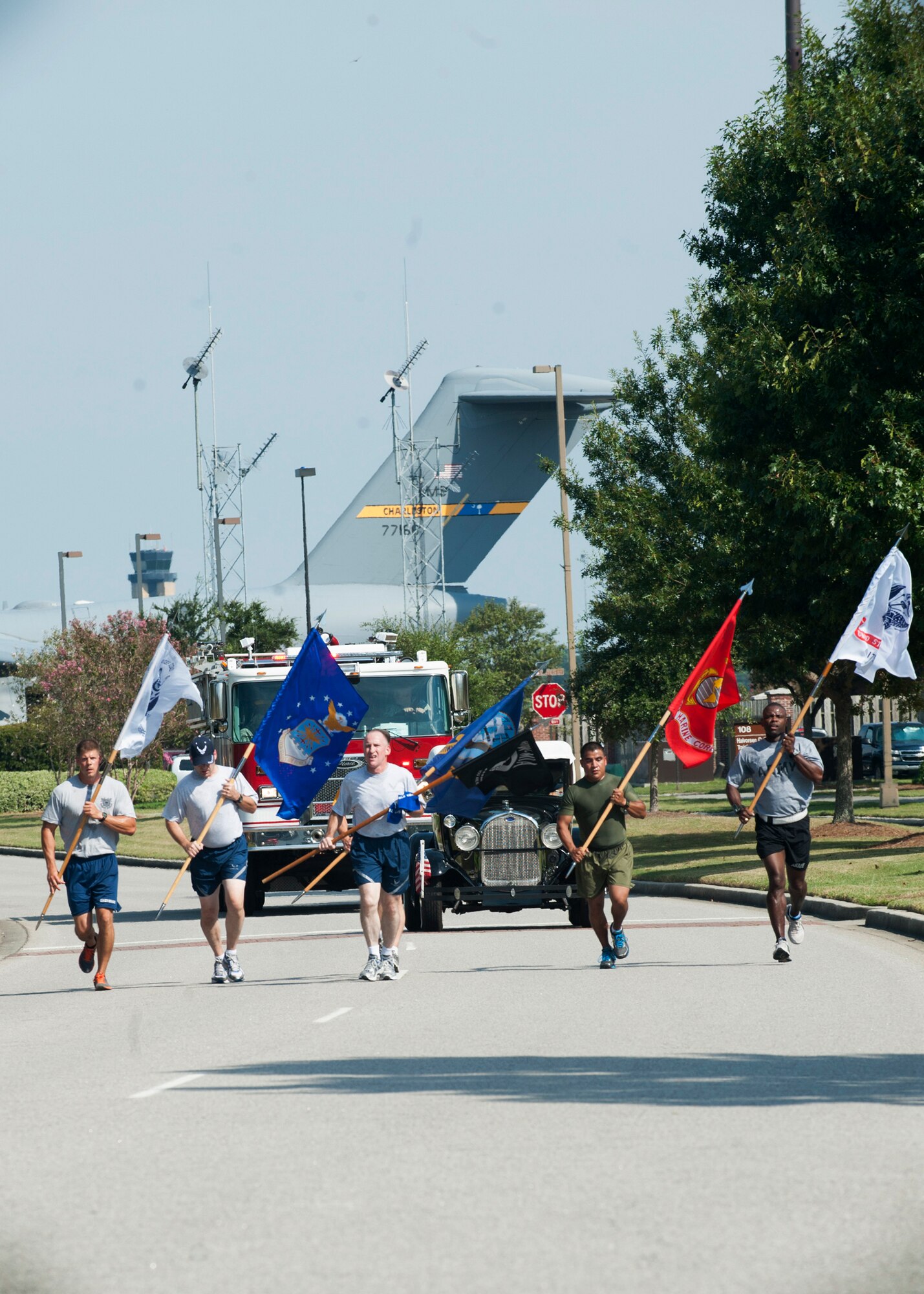 Members from each military branch  run with their respective service flags to the base parade grounds for the start of the Prisoner of War/Missing in Action Retreat ceremony Sept. 21, 2012, at Joint Base Charleston – Air Base, S.C. Teams from various joint base units held a running vigil at the base track, running the POW/MIA flag around the track for 24 hours. (U.S. Air Force photo / Staff Sgt. Katie Gieratz)